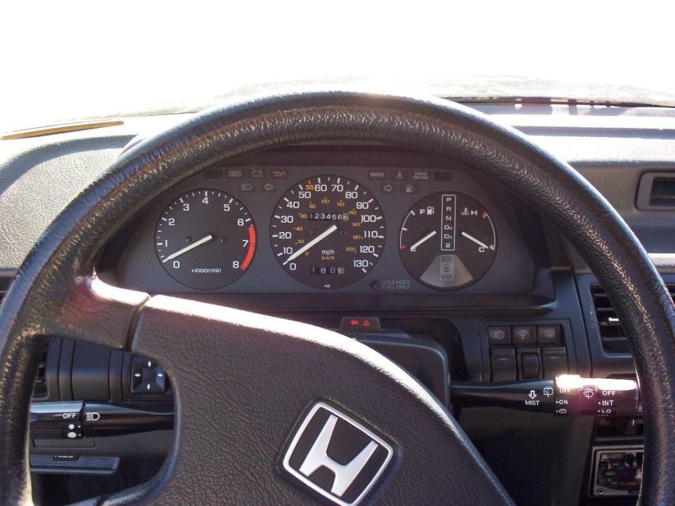 Honda instrument cluster and steering wheel viewed from driver seat