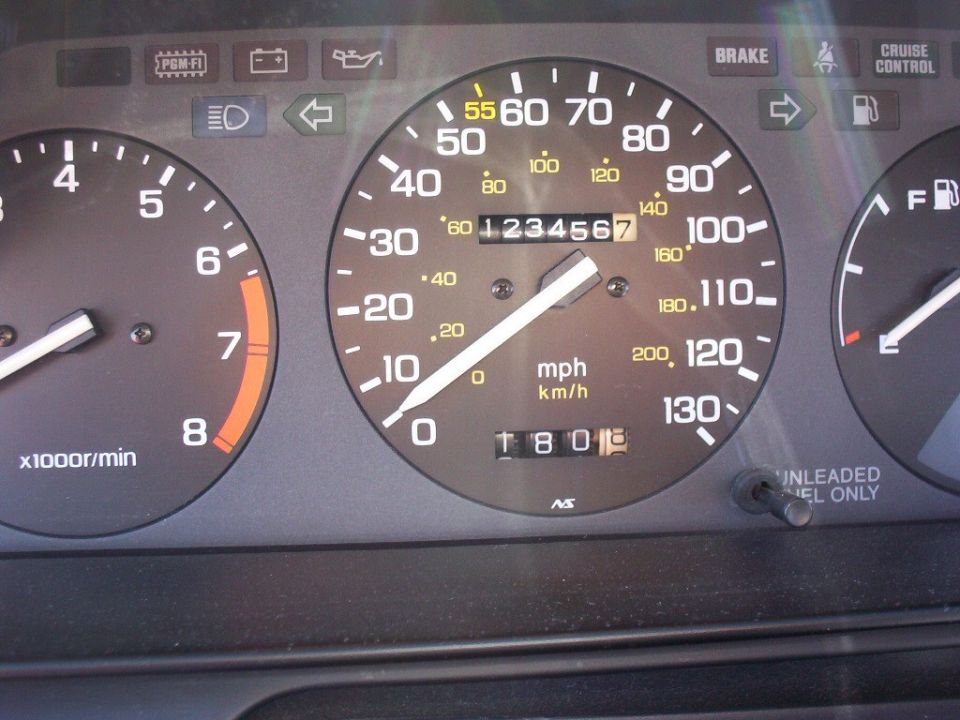 Honda gauge cluster with 130 mph speedometer, odometer at 123456.7 miles, tachometer and fuel gauge visible.