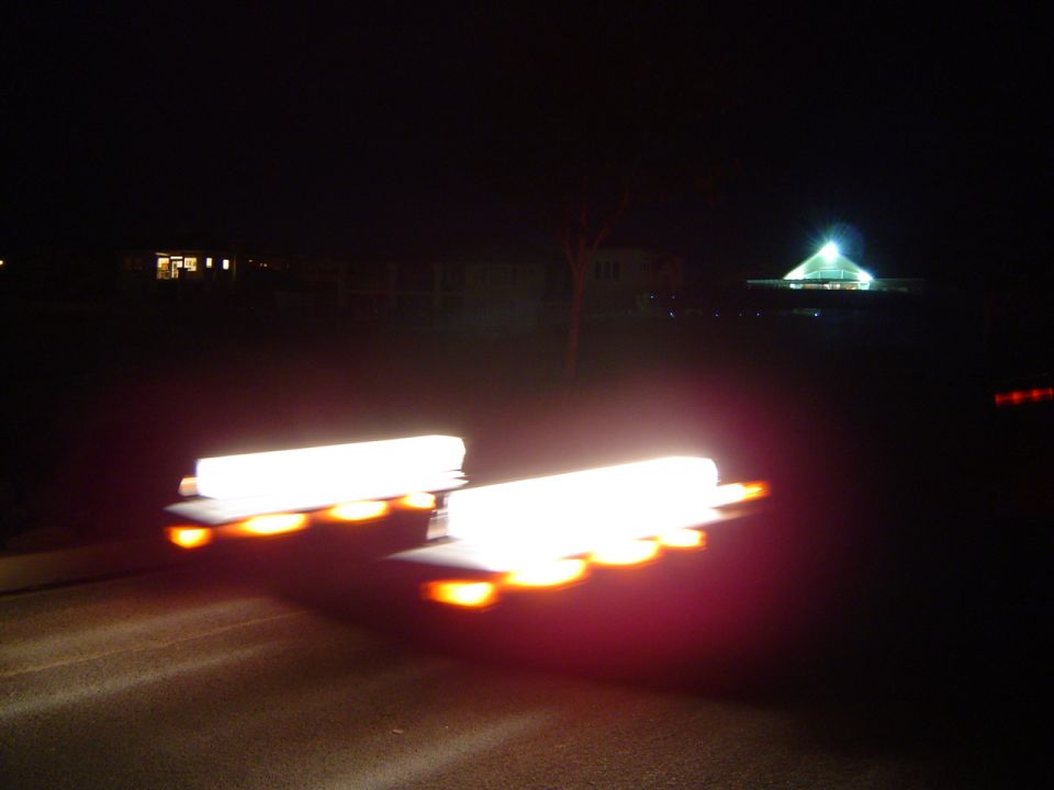 Blurred amber emergency light bar glowing at night