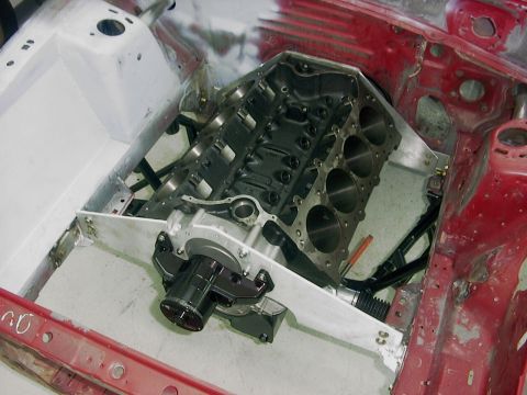 1990 Ford Mustang - Engine block installed in a red car chassis, with the Supermotors.net logo visible in the lower right corner.