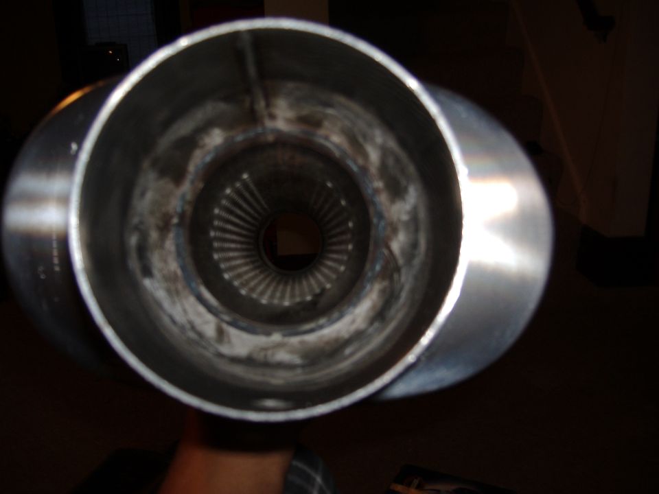 Inside view of a metal exhaust pipe with internal baffles