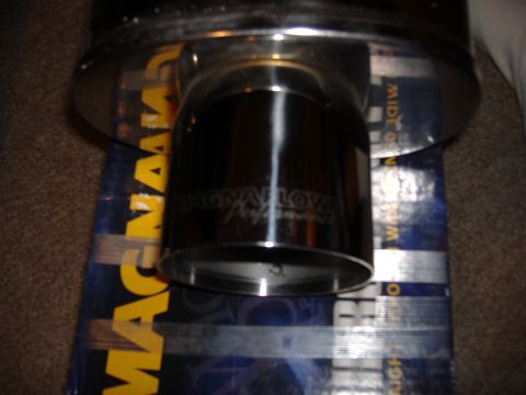 1998 Ford Taurus - A shiny Magnaflow exhaust tip rests on its box, showing the brand name.