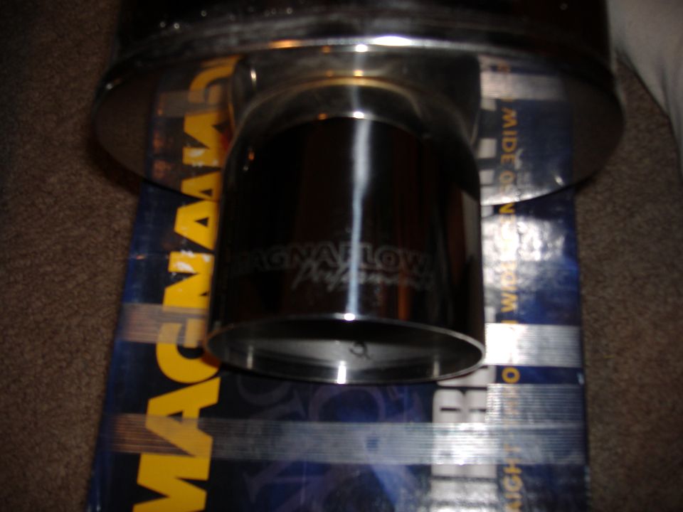 Close-up of a chrome Magnaflow exhaust tip sitting on its packaging