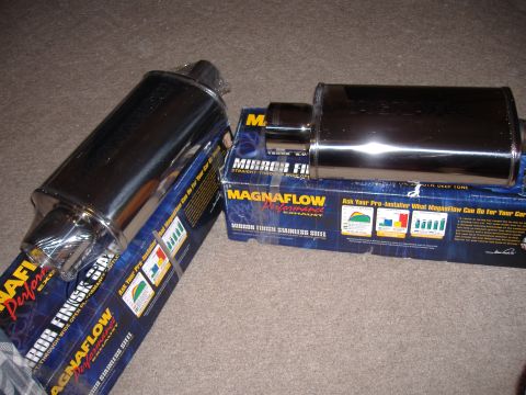 1998 Ford Taurus - Two new Magnaflow exhaust mufflers are displayed on their product packaging.