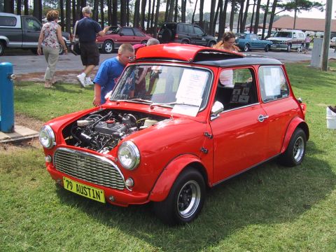 1968 Shelby GT500 - A red Austin Mini is displayed with its hood open, revealing the engine compartment.