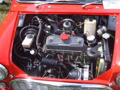 1968 Shelby GT500 - Close-up of a red Mini Cooper's engine compartment, showing the engine, hoses, and other mechanical components.