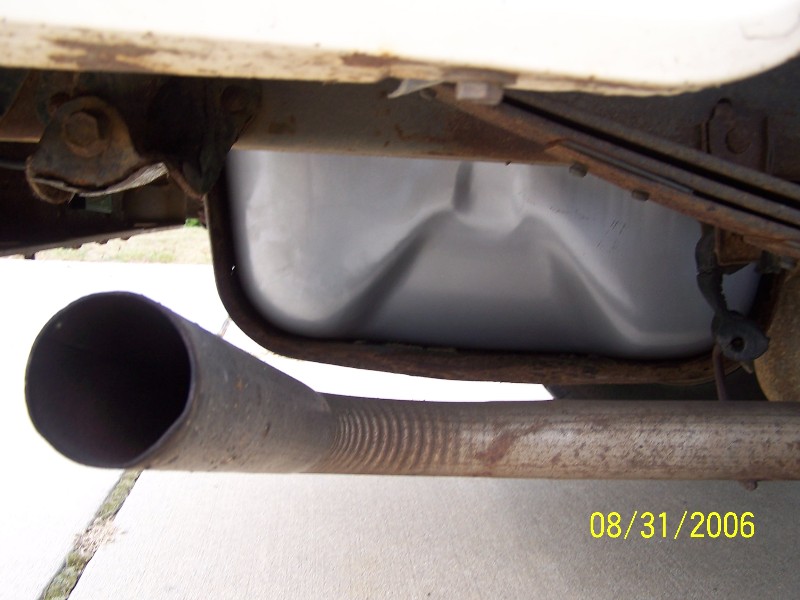 Exhaust pipe and fuel tank underside of a vehicle