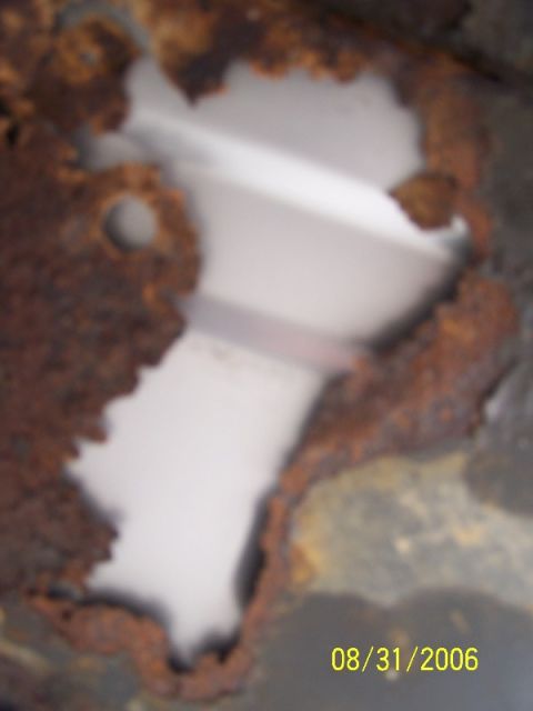 1992 Ford Bronco - Rusted metal panel with a hole, showing internal structure. Date stamp visible.