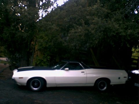 1972 Ford Ranchero - Side view of a white 1972 Ford Ranchero with a black hood stripe.