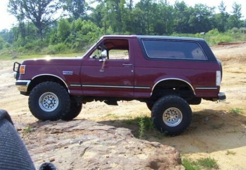 1989 Ford Bronco - This 1989 Ford Bronco is seen from a 3/4 front angle, parked on a dirt and rock-covered area.