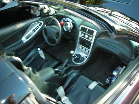 1992 Ford Crown Victoria - The interior of a modified car features racing seats and additional gauges for performance monitoring.