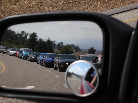 1992 Ford Crown Victoria - Traffic jam seen in side mirror, with several cars lined up on the road.
