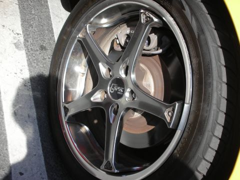1992 Ford Crown Victoria - A close-up shot focuses on a custom wheel, revealing the tire, brake system, and a prominent G-Tec logo.
