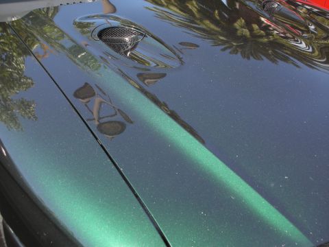 1992 Ford Crown Victoria - Close-up of a green metallic car hood vents.
