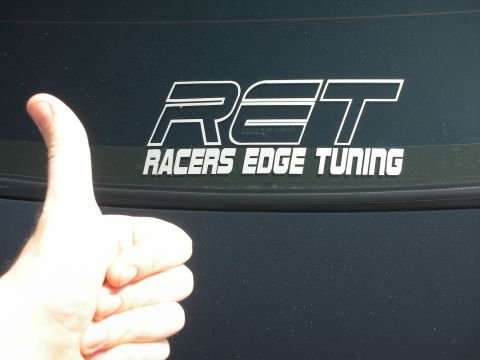 1992 Ford Crown Victoria - A hand gives a thumbs up next to a sticker that reads 'Racers Edge Tuning' on a vehicle's window.