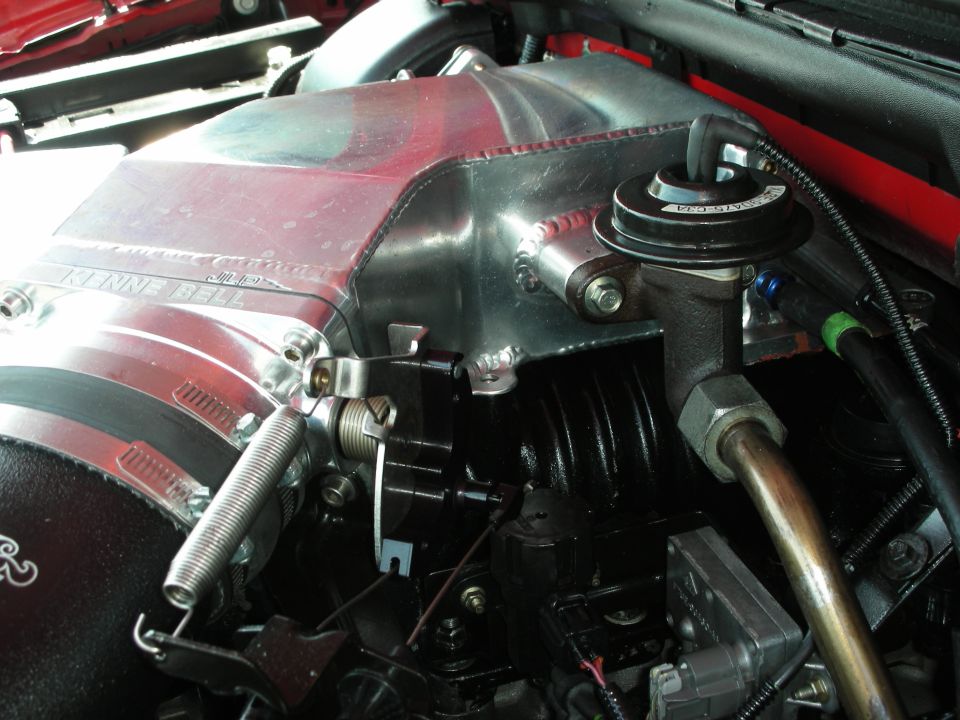 Polished aluminum intake manifold with KENNE-BELL logo, engine components visible