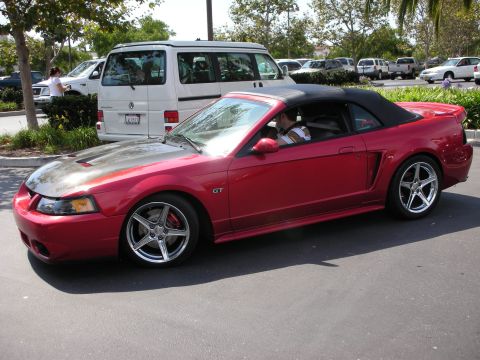 1992 Ford Crown Victoria - Red convertible sports car with carbon fiber hood and GT badging parked on asphalt.