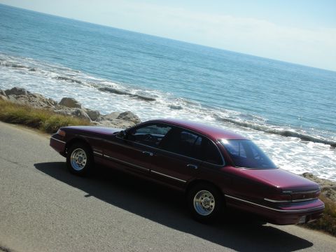 1992 Ford Crown Victoria - Maroon 1992 Ford Crown Victoria parked on a coastal road.