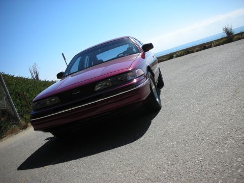 1992 Ford Crown Victoria - Maroon 1992 Ford Crown Victoria parked on a road overlooking the ocean.