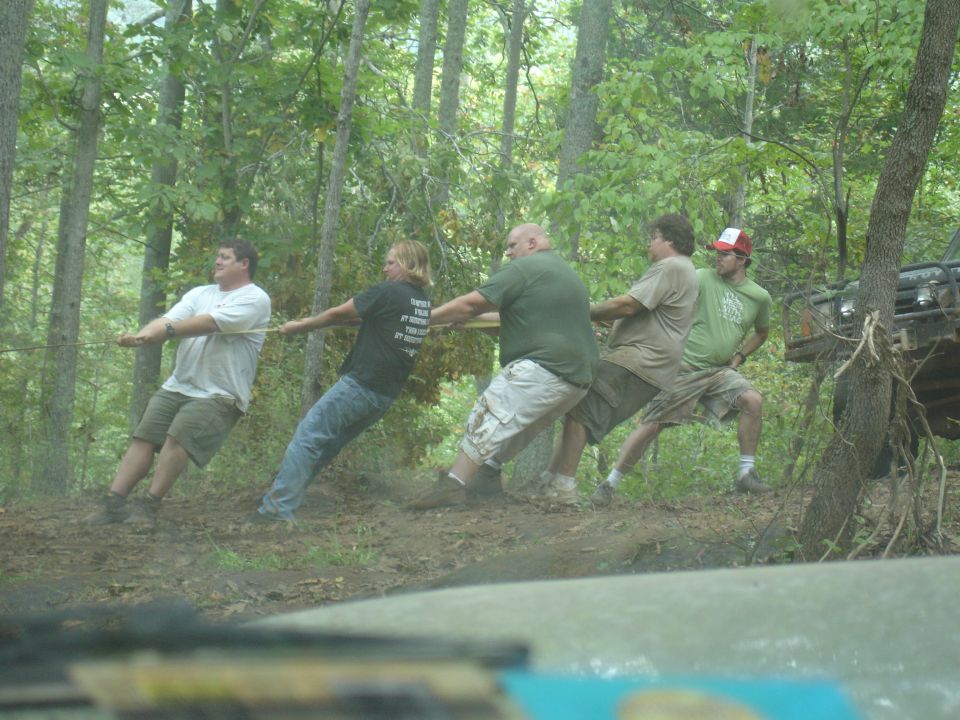 Off-road vehicle in woods during tug of war