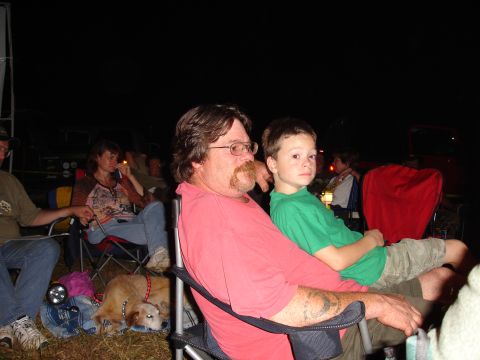 1996 Ford Bronco - People gathered outdoors at night, with a man and boy in the foreground.