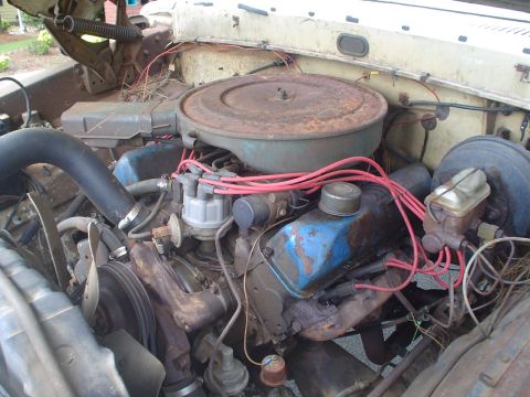 1967 Ford F-250 - Engine bay of a 1967 Ford F-250, showing the V8 engine, air cleaner, and distributor cap and wires.