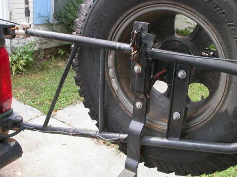 1990 Ford Bronco - Close-up of a spare tire carrier attached to the rear of an unidentified vehicle.