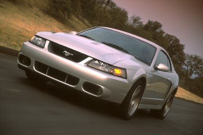 2003 Ford Mustang - Front 3/4 view of a silver 2003 Ford Mustang on a road.