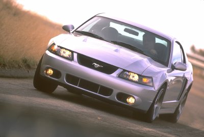 2003 Ford Mustang - Silver 2003 Ford Mustang shown from the front-right angle on a road.