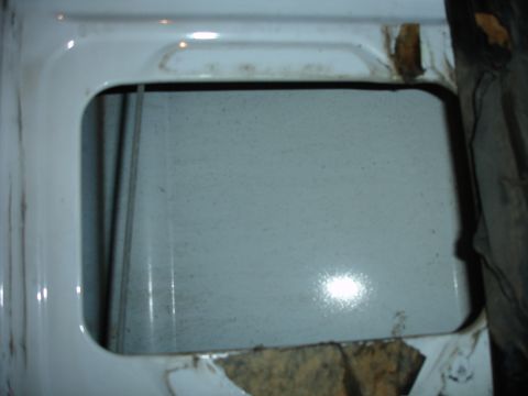 1996 Ford Bronco - Close-up view of a white tailgate a rectangular opening, likely for a window or vent.