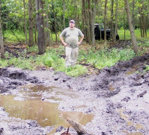 1978 Ford Bronco - Off-road vehicle stuck in mud pit with a man observing the scene.