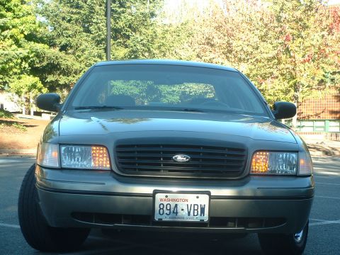 2000 Ford Crown Victoria - Front view of a gray 2000 Ford Crown Victoria, showing its grille and headlights.