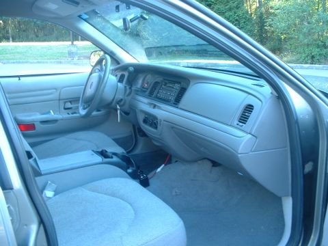 2000 Ford Crown Victoria - The interior of a 2000 Ford Crown Victoria is visible from the passenger side door.