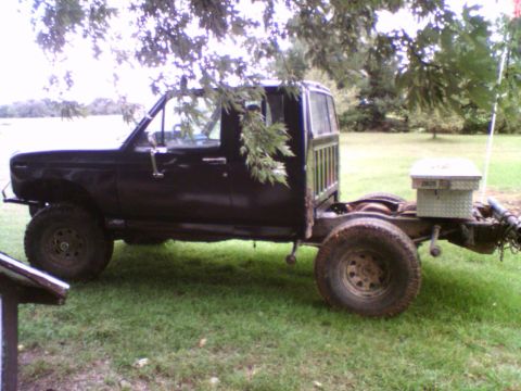 1985 Ford F-150 - This extended cab pickup truck chassis, likely from the early to mid-1980s, is viewed from the side and features a toolbox mounted on the r…
