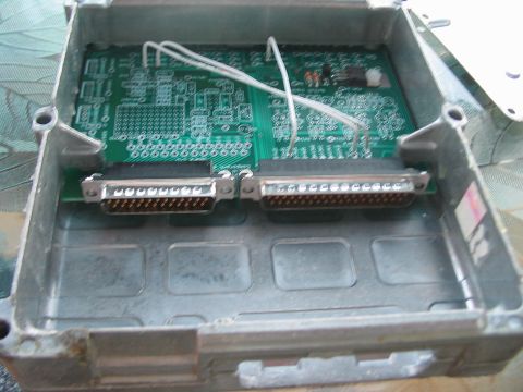 1991 Ford Bronco - An open engine control unit reveals its internal circuit board and wiring connectors.