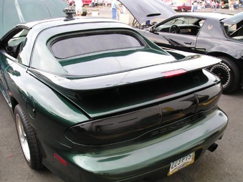 1994 Pontiac Trans Am - Two Pontiac Trans Ams parked together, one green and one black, with hoods open.