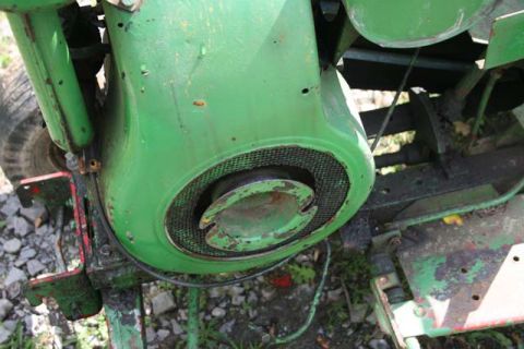 1987 Ford Bronco - The engine of a green tractor is shown in detail, with visible wear and tear.