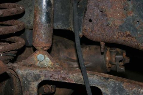 1987 Ford Bronco - Heavily rusted suspension components, likely from an older vehicle, are visible in this close-up shot.