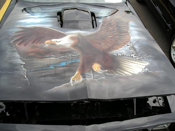 Hood with airbrushed eagle in flight over a rocky landscape