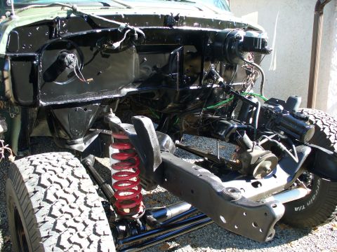 1978 Ford Bronco - The vehicle's front chassis and suspension are exposed, indicating ongoing restoration or repair work.