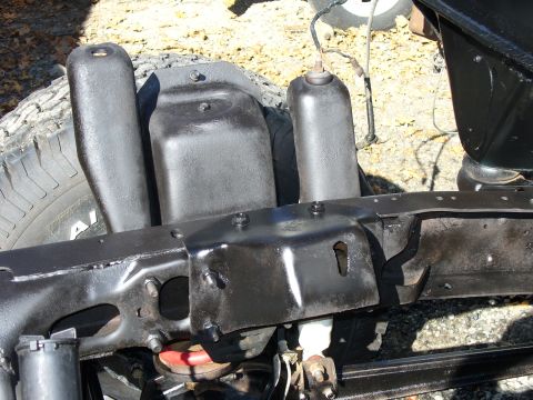 1978 Ford Bronco - Close-up view of a vehicle's frame and suspension components, with a tire in the background.