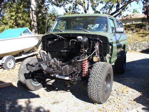 1978 Ford Bronco - 1978 Ford Bronco undergoing engine work, showing the chassis and suspension components.