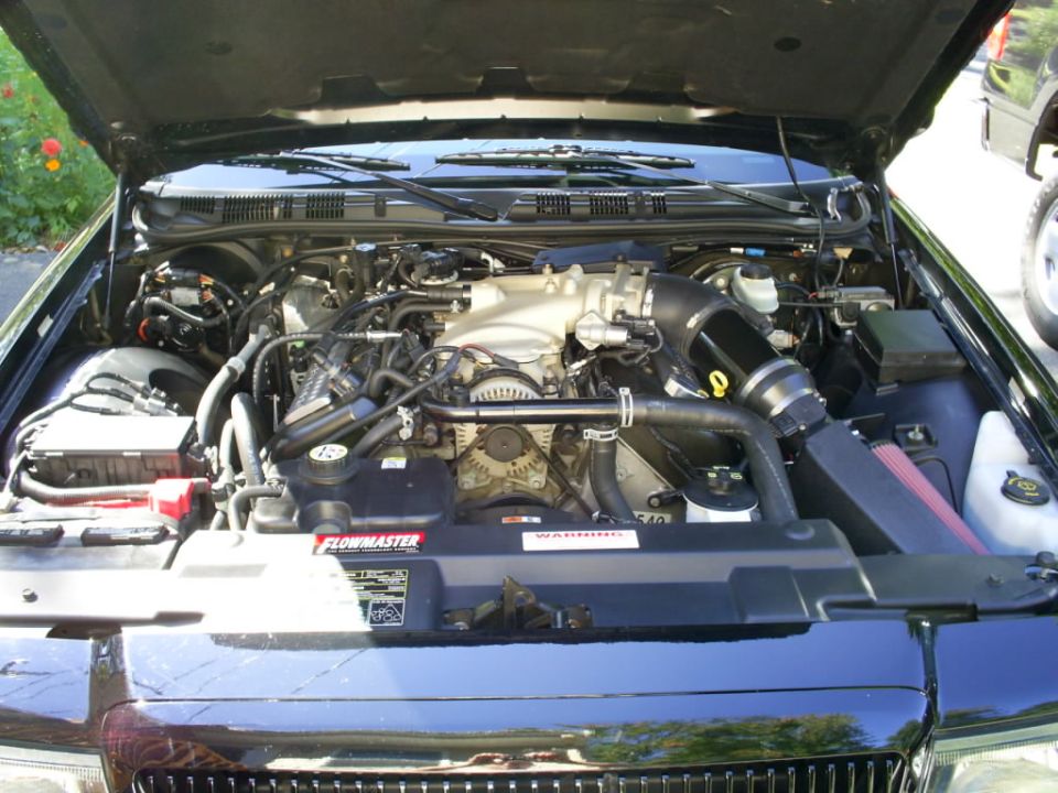 Black 2003 Mercury Marauder engine bay with a Flowmaster sticker on the radiator cover