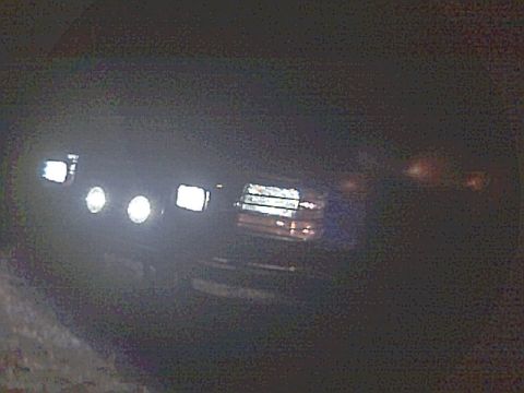1994 Ford Bronco - Front view of a 1994 Ford Bronco with its lights illuminated in the dark.
