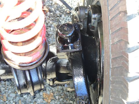 1978 Ford Bronco - Front axle assembly detail, including a coil spring and part of a tire.