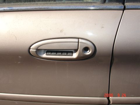 1993 Ford Taurus - Close-up of a car's door handle, a keypad for entry and a visible date stamp.