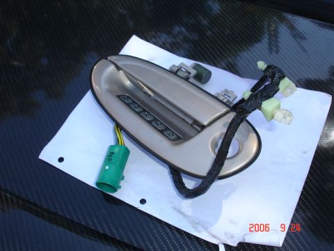 1993 Ford Taurus - A car door handle with a keypad and electrical connectors is shown, with a date stamp of 2006.