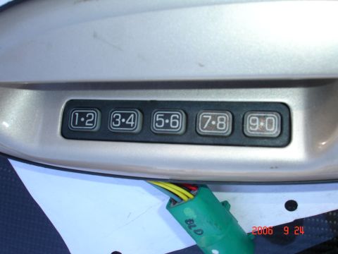 1993 Ford Taurus - Close-up of a vehicle's door keypad, showing the numbered buttons and wiring harness.