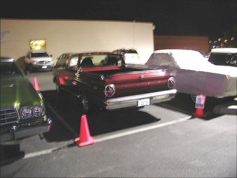 1967 Ford Ranchero - Rear view of a 1967 Ford Ranchero, parked at night with other cars.