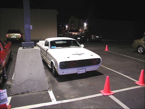 1967 Ford Ranchero - A white Ranchero pickup truck is parked at night, a custom grille and hood scoop. The vehicle appears to be from the early 1960s.